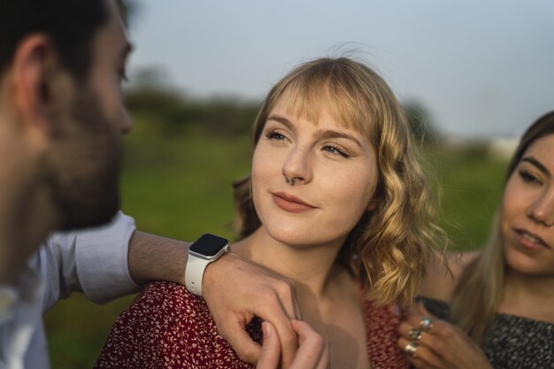 Shallow focus shot of Spanish Caucasian young friends hanging out in a park