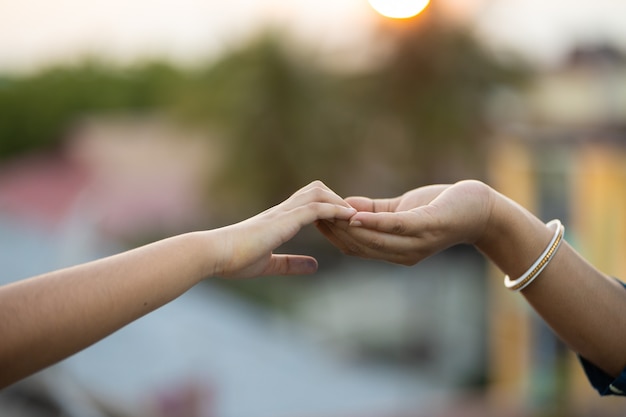 Free photo shallow focus shot of two hands touching each other gently