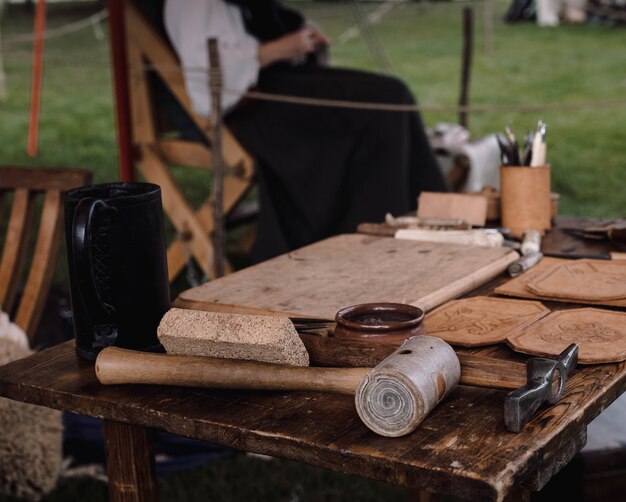 Shallow focus shot of woods with mallet and pickaxe on a table