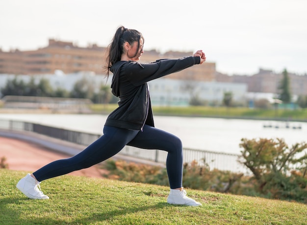 Shallow focus shot of a young Caucasian female during her workout in the park