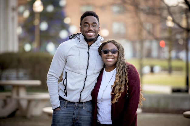 Shallow focus of two African-American friends smiling and posing together