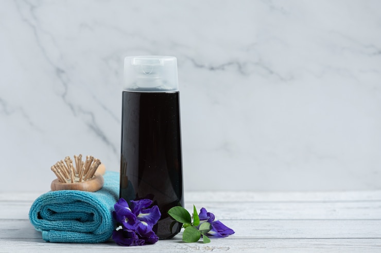 Free Photo shampoo bottle of butterfly pea flower put on white wooden background