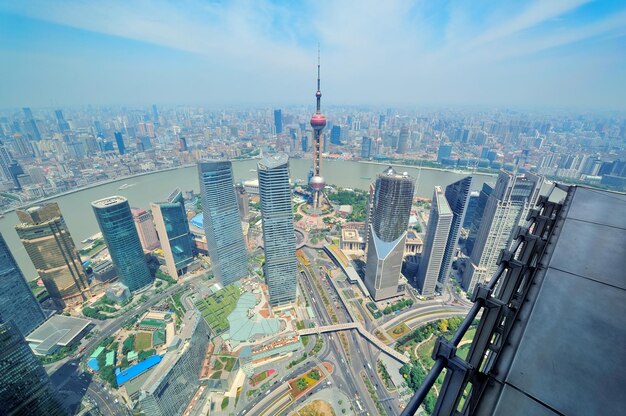 Вид с воздуха на город Шанхай днем с голубым небом и облаком с башней "Восточная жемчужина"