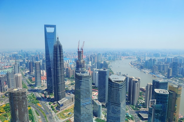 Shanghai city aerial view with urban architecture and blue sky in the day.