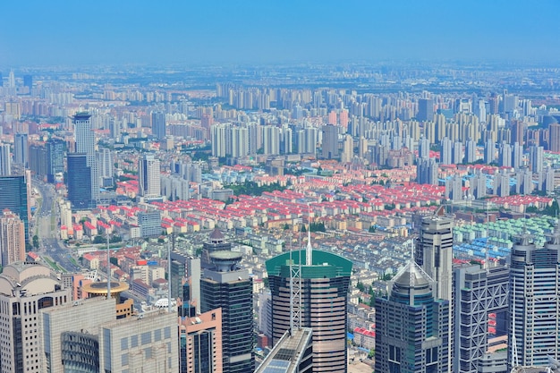 Shanghai city aerial view with urban architecture and blue sky in the day.