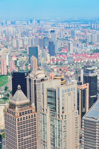 Shanghai city aerial view with urban architecture and blue sky in the day.