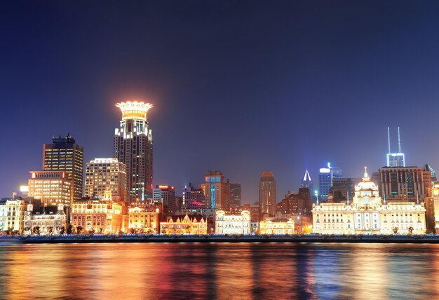 Shanghai historic architecture at night lit by lights over Huangpu River