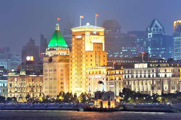 Shanghai urban architecture over river at dusk