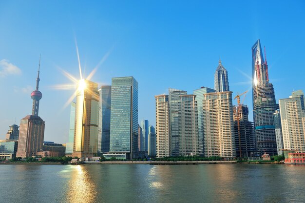 Shanghai urban architecture and skyline with sun light reflection over river