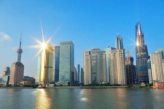 Shanghai urban architecture and skyline with sun light reflection over river