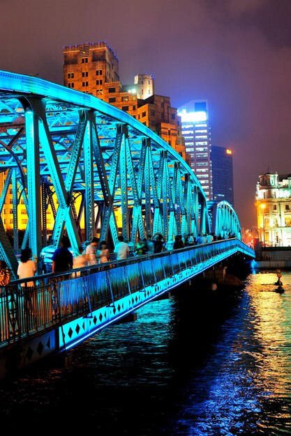 Shanghai Waibaidu bridge at night with colorful light over river