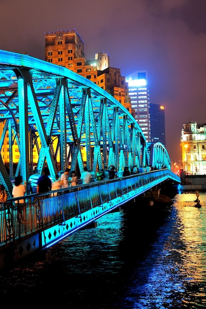 Shanghai Waibaidu bridge at night with colorful light over river