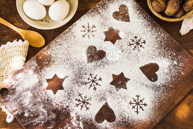 Shapes in flour near cooking ingredients