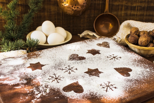 Free photo shapes in flour near ingredients and conifer twig