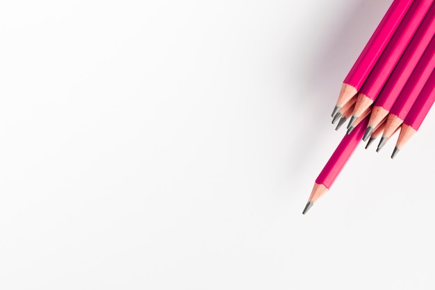 Sharp pink pencils bunch against white background