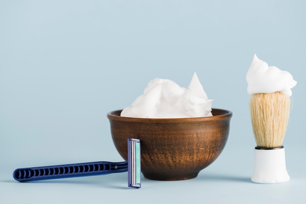 Shaving accessories over blue background