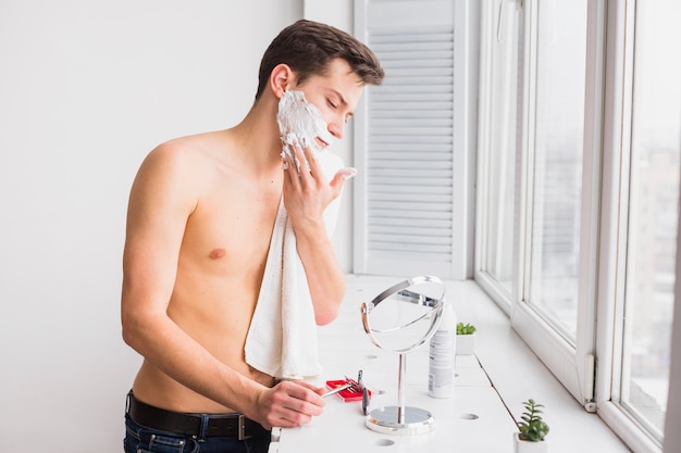 Shaving concept with attractive young man