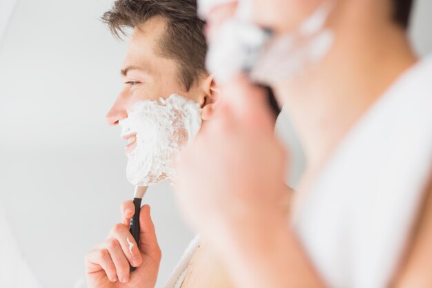 Shaving concept with attractive young man