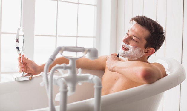 Shaving concept with attractive young man