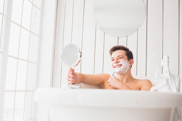 Shaving concept with attractive young man