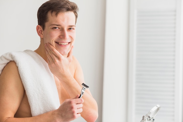 Shaving concept with attractive young man