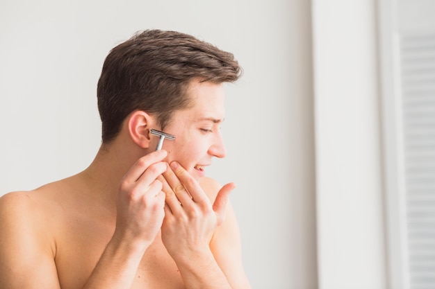 Shaving concept with attractive young man