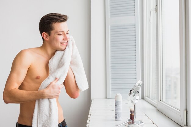 Shaving concept with attractive young man