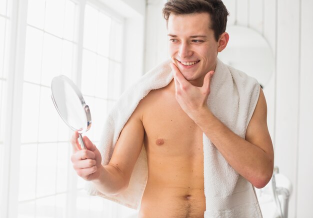 Shaving concept with attractive young man