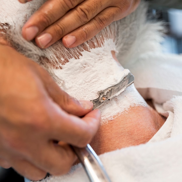 Shaving male neck with straight razor