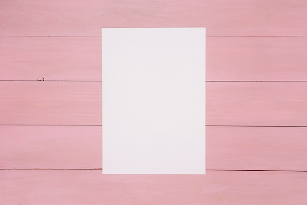 Free photo sheet of paper on painted wooden surface