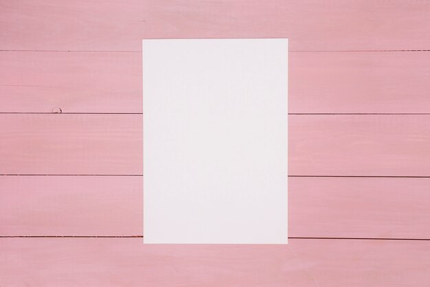 Sheet of paper on painted wooden surface