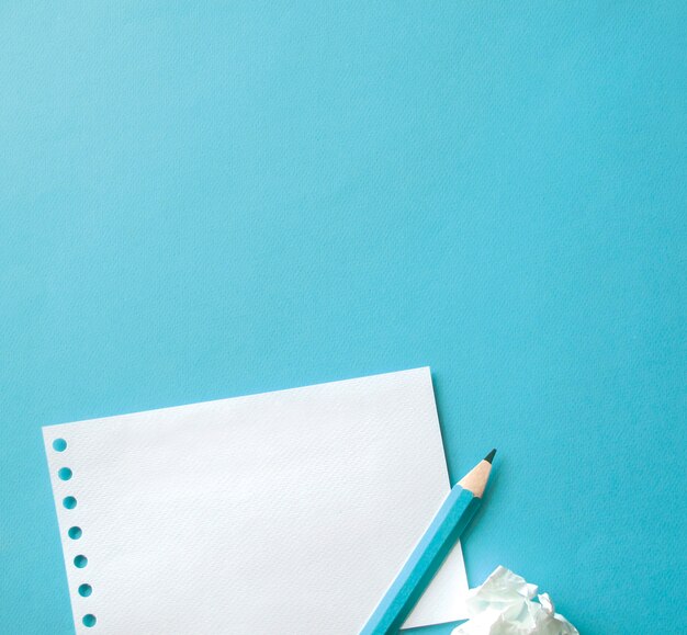 Sheet of paper and pen with blue background