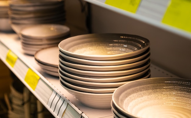 Free photo shelf with ceramic plates for sell in a tableware store