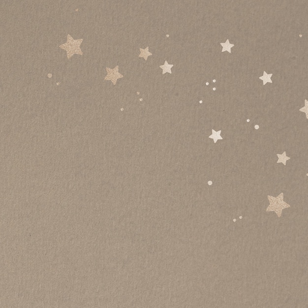 Foto gratuita stelle dorate scintillanti su sfondo beige