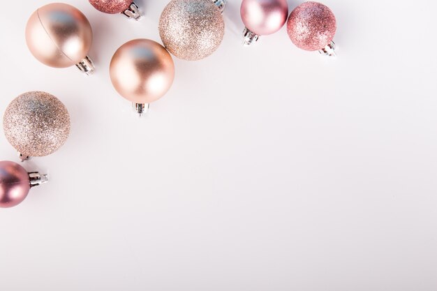Shining pink baubles on white