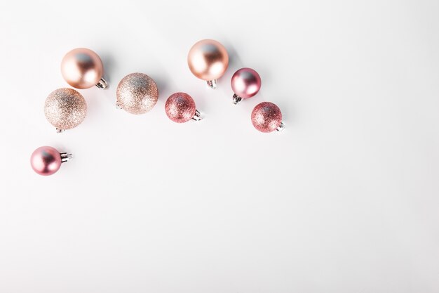 Shining pink baubles on white