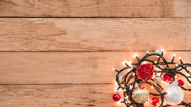 Shiny baubles with burning garland 