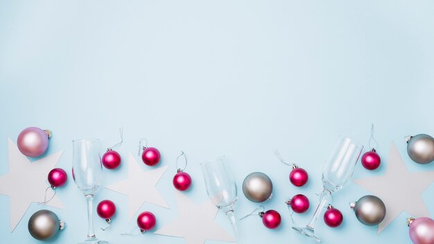 Shiny baubles with glasses on table