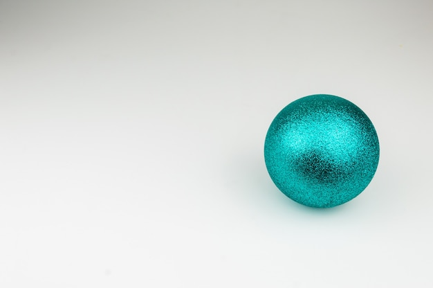 Shiny blue Christmas ball on white