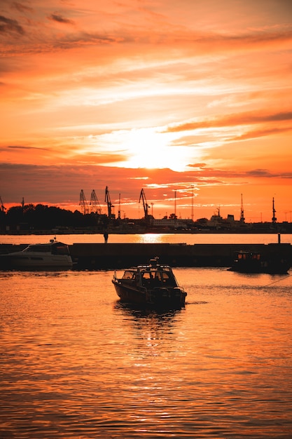 Ship on the sea with the beautiful sunset reflecting on the surface