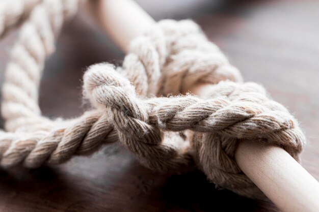 Ship white ropes knot tied on a bar close-up