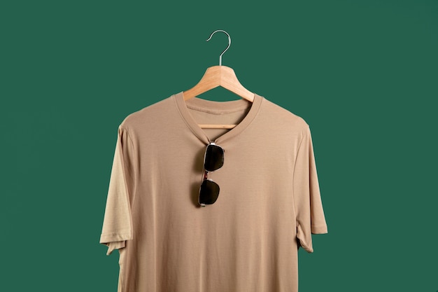 Free photo shirt on hanger with green background