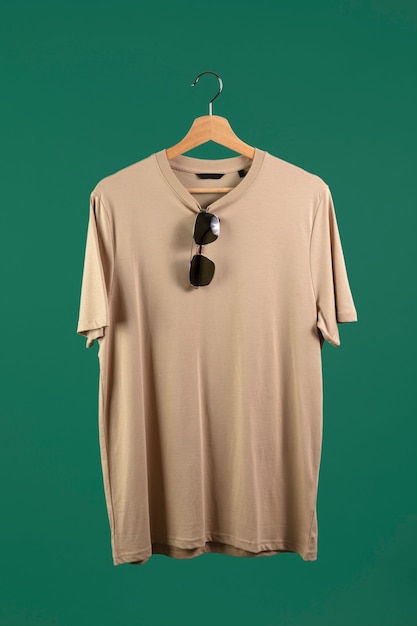 Free photo shirt on hanger with green background