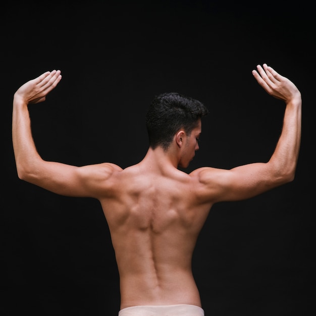 Shirtless ballet dancer with muscular arms and back