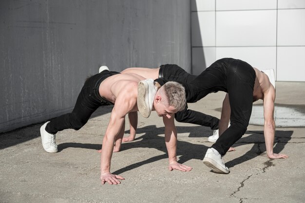 Shirtless hip hop artists dancing outside