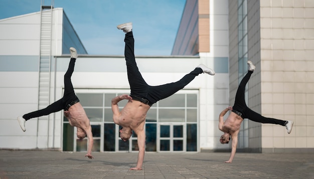 Shirtless hip hop dancers outisde