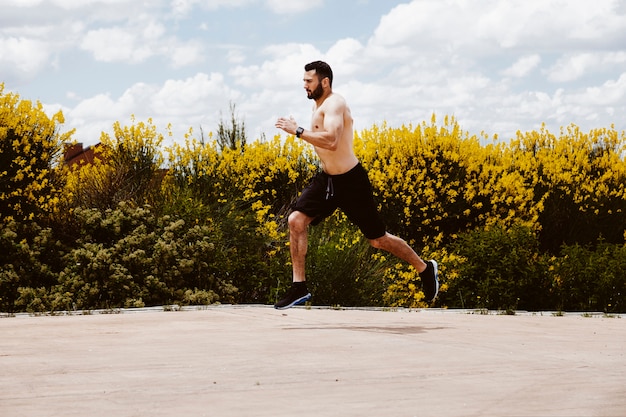 Free photo shirtless male athlete running