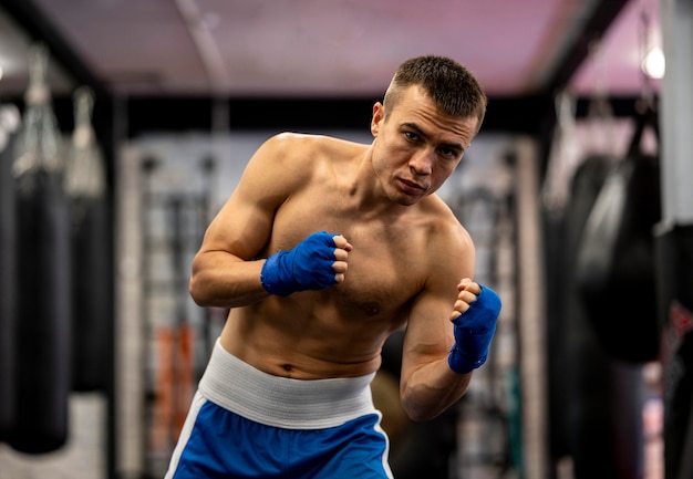 Shirtless male boxer working out