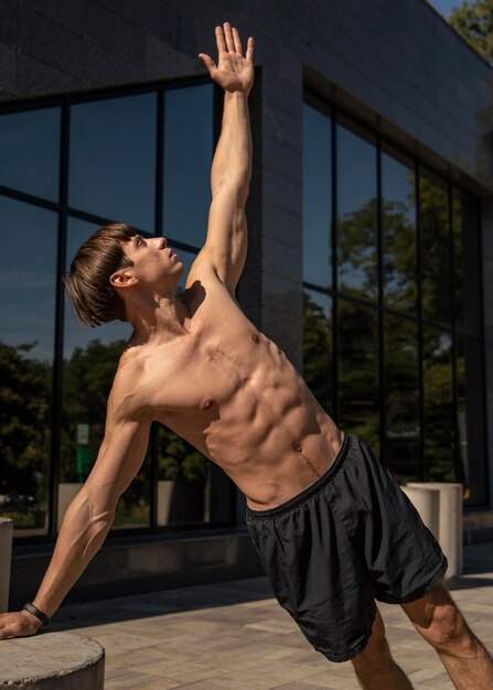 Shirtless man working out outdoors