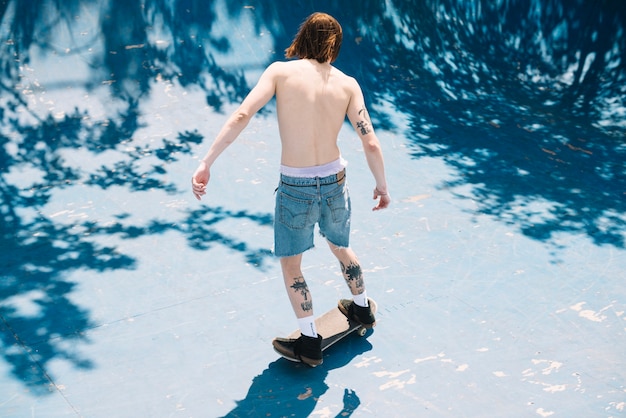 Shirtless skater on board